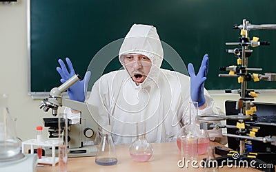 A scientist in a chemical laboratory is disappointed by a failed experiment with chemicals Stock Photo
