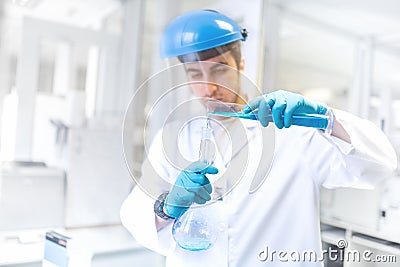 Scientist doctor using laboratory flask for taking samples from test tube Stock Photo