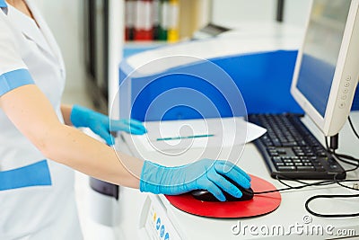 Scientist entering data of blood sample in computer at laboratory Stock Photo