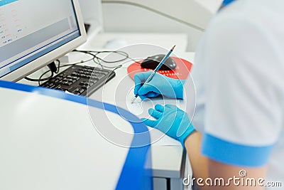 Scientist entering data of blood sample in computer at laboratory Stock Photo