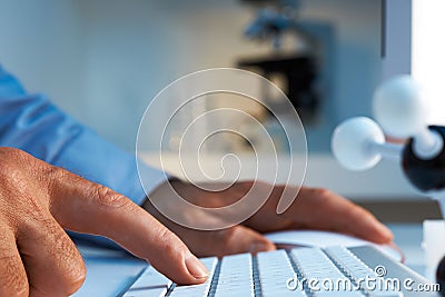 Scientist entering data into computer Stock Photo