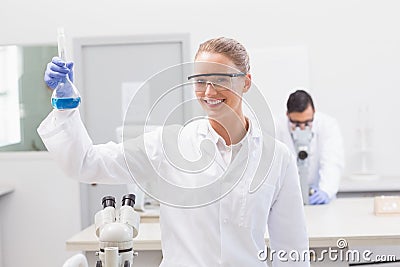 Scientist examining blue precipitate in baker Stock Photo