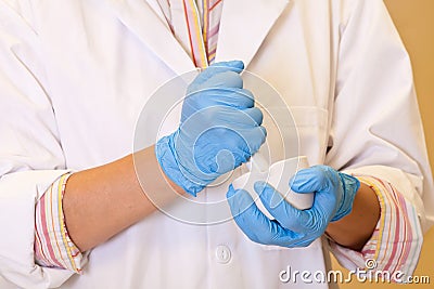 Scientist grinds up compound in porcelain mortar Stock Photo