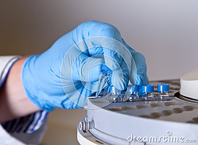 Scientist holds a chemical sample bottle Stock Photo