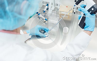 Scientist in lab conducting biotechnological experiment Stock Photo