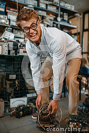 Scientist lifts heavy electrical device in lab Stock Photo