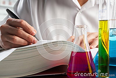 Scientist looking for data in journal Stock Photo