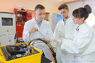 Scientist looking at readings from machine Stock Photo