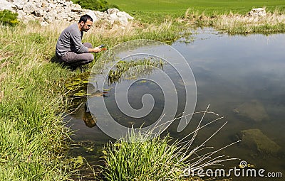 Scientist measuring environmental water quality in a wetland Stock Photo
