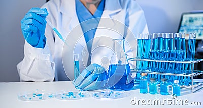 Scientist mixing chemical liquids in the chemistry lab. Researcher working in the chemical laboratory Stock Photo