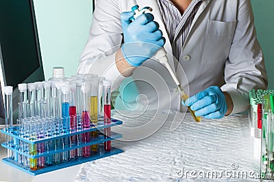 Scientist pipetting sample for study in tube Stock Photo