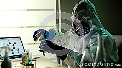 Scientist in ppe suits with test tubes working in laboratory Stock Photo