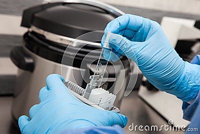 Scientist preparing slides with tissue samples for immunohistochemistry assay in the laboratory. Scientist at the Stock Photo