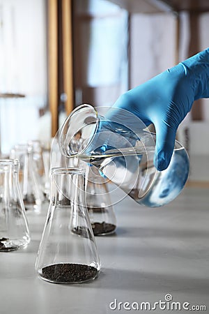 Scientist preparing soil extract at table, closeup. Stock Photo