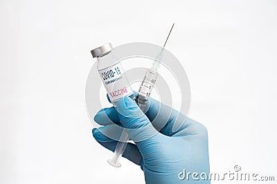 Scientist`s hand wearing blue gloves against white background and holding Covid-19 vaccine Stock Photo