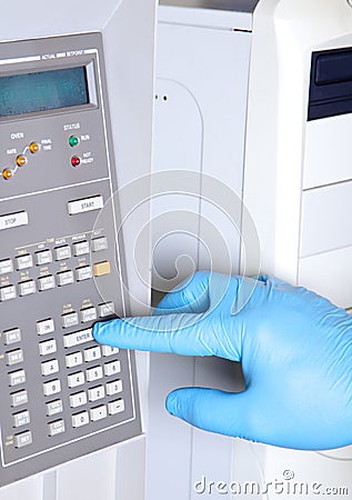 Scientist sets chromatograph oven temperature Stock Photo