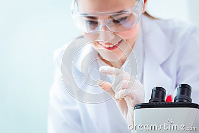 Scientist smiled while holding the test results for the virus vaccine in a science medical research lab Stock Photo