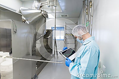 Scientist stand near chromed barrels Stock Photo