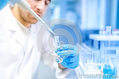 Scientist using medical tool for extraction of liquid from samples in special laboratory or medical room Stock Photo
