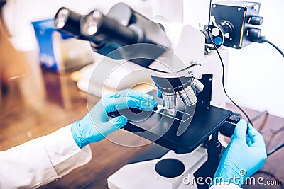 Scientist using microscope for chemistry test samples and probes. medical and scientific detail equipment or tools Stock Photo