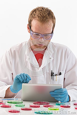 Scientist using tablet in microbiology laboratory Stock Photo