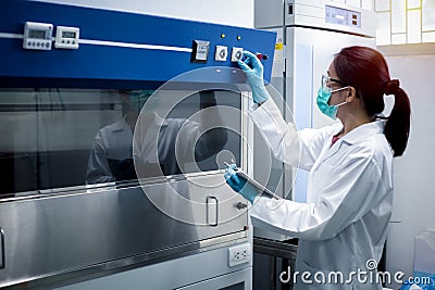 Scientist woman checking the fume hood in the laboratory Stock Photo