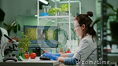 Scientist woman researcher typing biochemistry expertise on computer Stock Photo