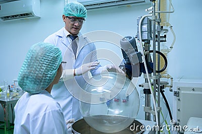 Scientists and assistants are in the machine room extracting oil Stock Photo