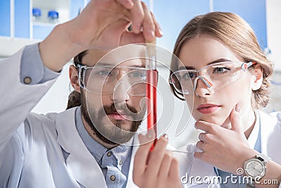 Scientists with chemical sample Stock Photo