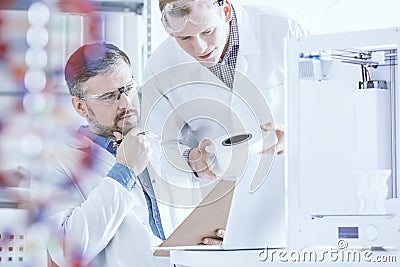 Scientists conferring in laboratory Stock Photo