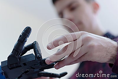 Scientists engineers designing small human robot, setting artificial intelligence humanoid robot. Artificial intelligence, Stock Photo