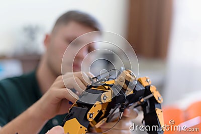 Scientists engineers designing small human robot, setting artificial intelligence humanoid robot. Artificial intelligence, Stock Photo