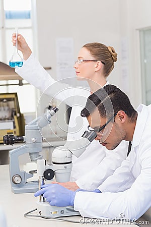 Scientists examining blue precipitate Stock Photo