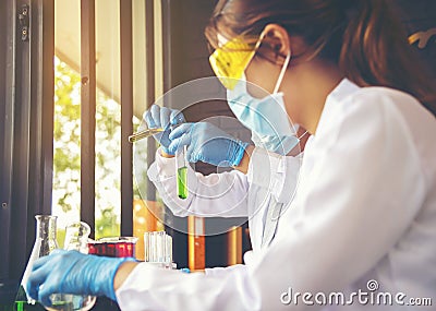 Scientists are experimenting with chemicals in science tubes at Stock Photo