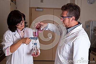 Scientists holding labware Stock Photo