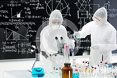 Scientists manipulating lab tools Stock Photo