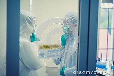 Scientists talking and wearing protection glasses satisfied with great results of completed Stock Photo