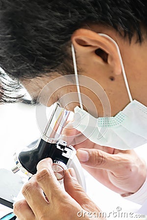 Scientists are using a microscope. Stock Photo