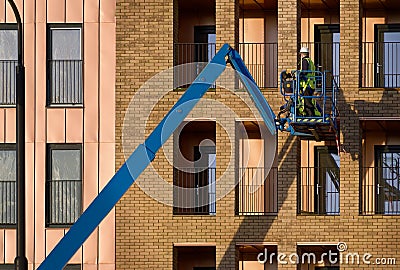 Glasgow, UK, 13th January 2024, Scissor lift being operated by construction workmen for safe access at height Editorial Stock Photo