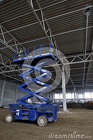 Scissor lift platform inside industrial building Editorial Stock Photo