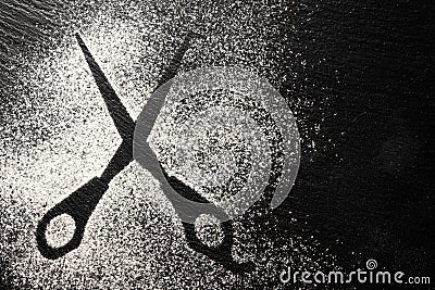 Scissors silhouette made with flour on dark texture background, up horizontal view Stock Photo