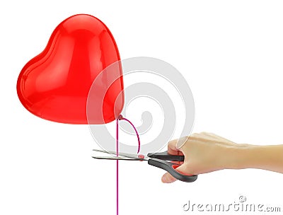 Scissors about to set free heart balloon Stock Photo