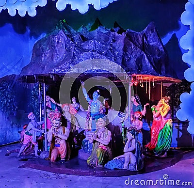 Sclupture of lord Krishna lifting mountain and saving life of villagers. Editorial Stock Photo