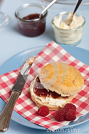 Scone with clotted cream and raspberry jam Stock Photo