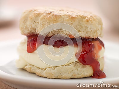 Scone Filled with Strawberry Jam and Clotted Cream Stock Photo