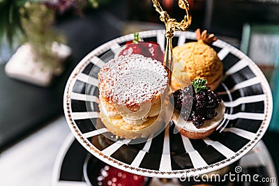 Scone Pie topping with icing and Blueberry Mini Tart on black and white plate. Dessert for afternoon tea Stock Photo