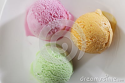 Scoop of delicious real fresh ice cream in Mango, Strawberry and Pistachio flavour. Stock Photo