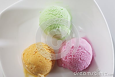 Scoop of delicious real fresh ice cream in Mango, Strawberry and Pistachio flavour. Stock Photo