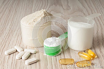 Scoop of protein, bcaa and creatine, omega3 in pills Stock Photo