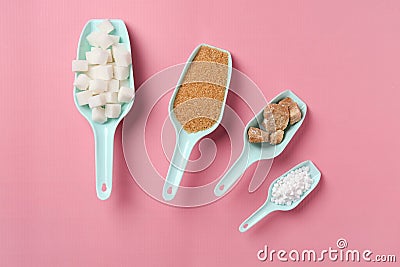 Scoops with different kinds of sugar and sweetener tablets on color background Stock Photo